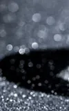 A polished diamond on a sparkly black background