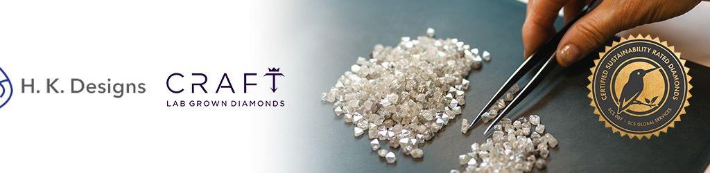 Loose diamonds on a table being picked up by a hand holding jewelry tweezers